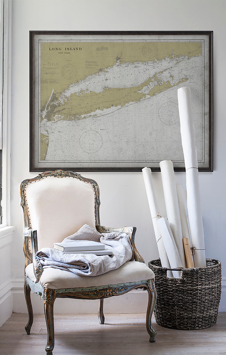 Vintage historic nautical chart of Long Island in room with white walls with vintage furniture and vintage decor.