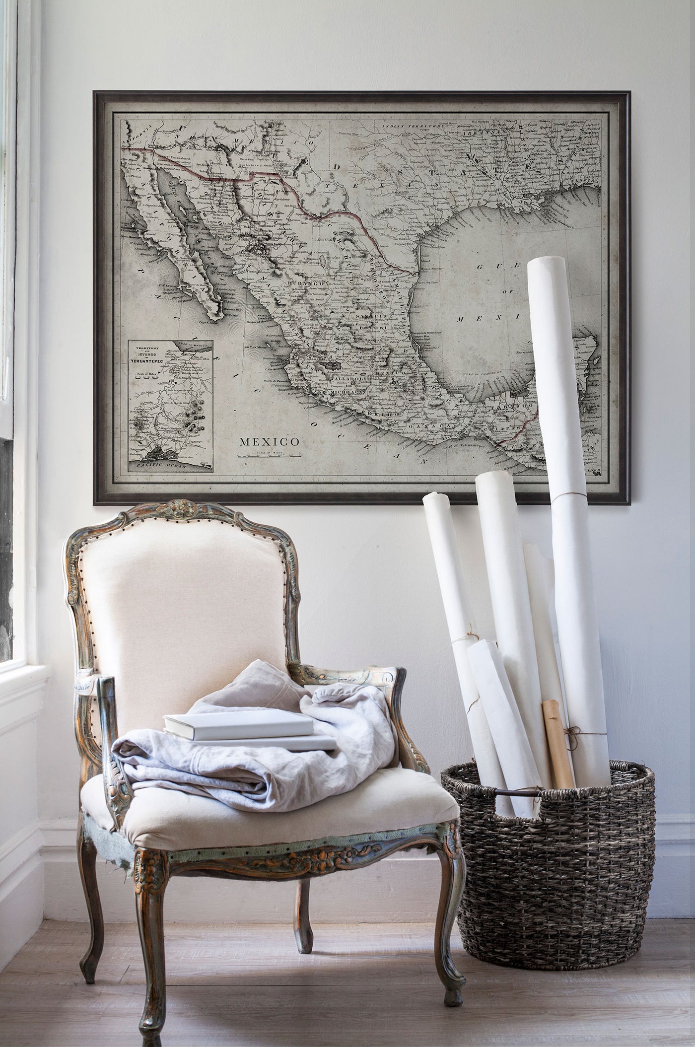 Vintage historic road map of Mexico in room with white walls with vintage furniture and vintage decor.