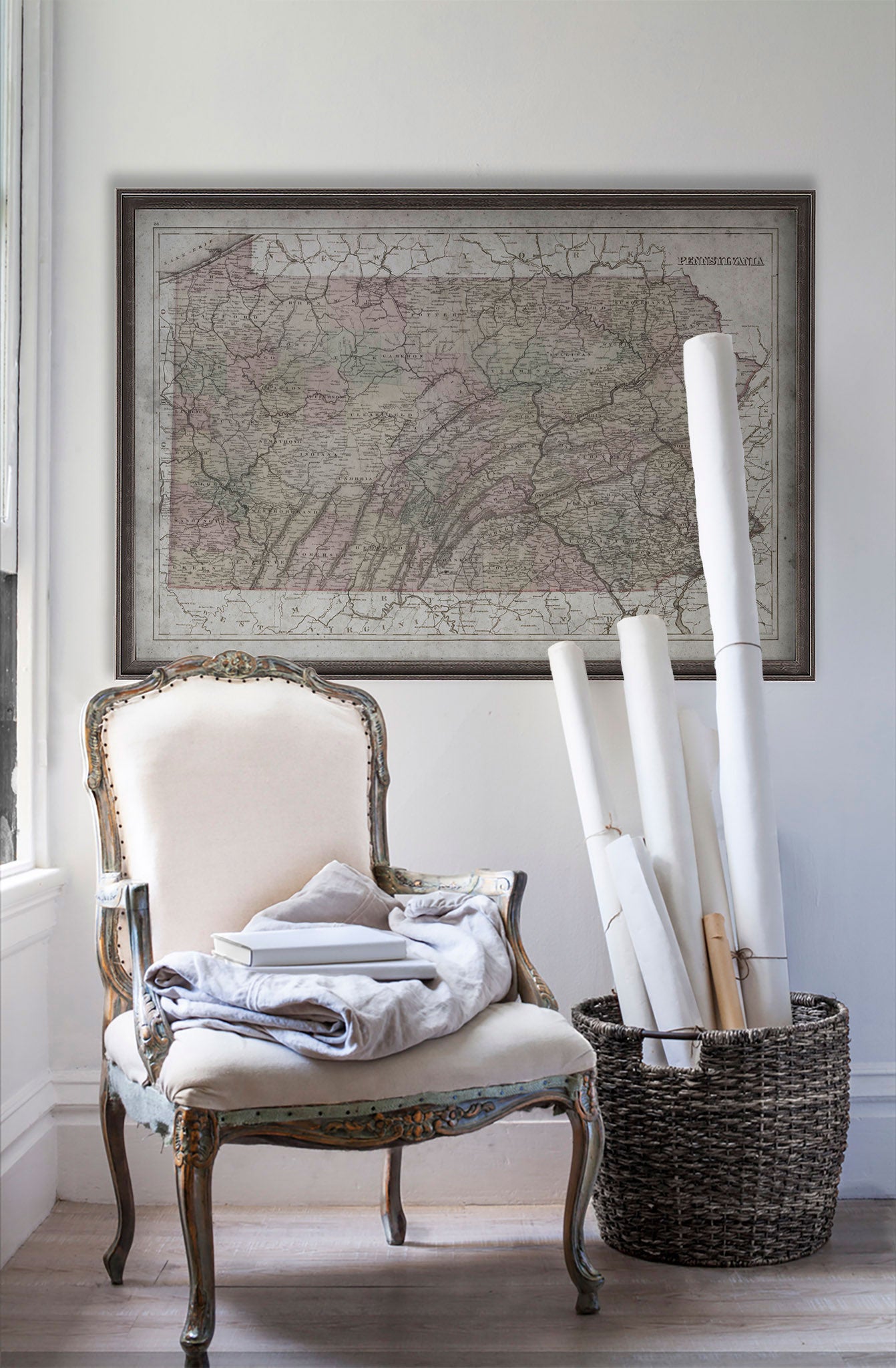 Vintage historic map of Pennsylvania in room with white walls with vintage furniture and vintage decor.