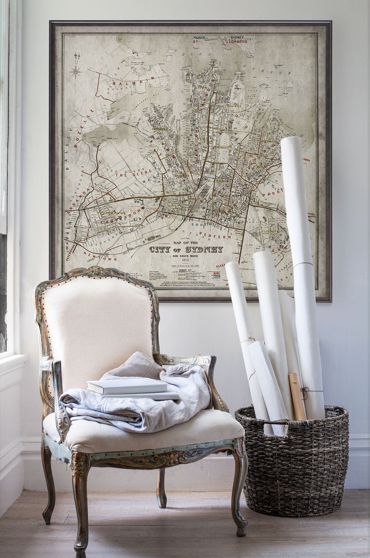 Vintage historic map of Sydney, Australia in room with white walls with vintage furniture and vintage decor.