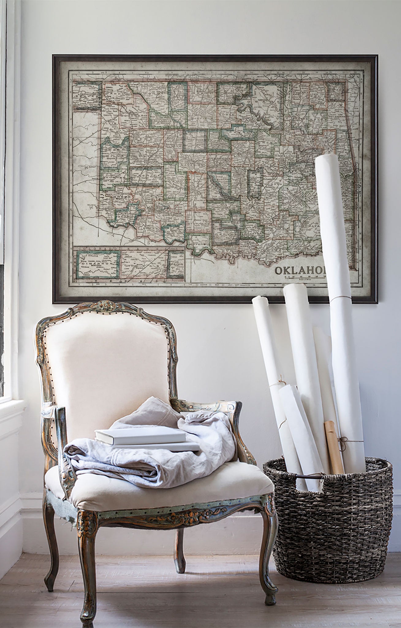 Vintage historic map of Oklahoma in room with white walls with vintage furniture and vintage decor.