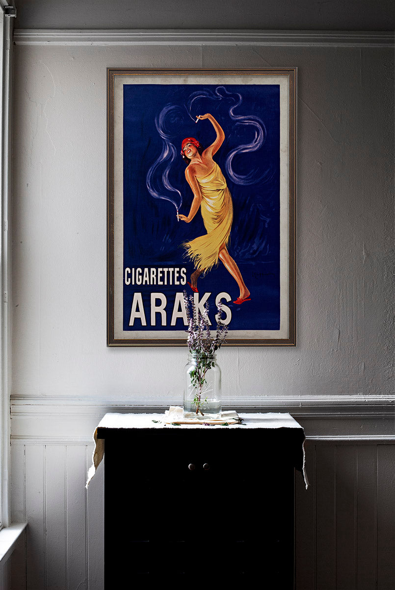 Cigarettes Araks vintage wall art poster on white wall with vintage furniture and vintage decor.