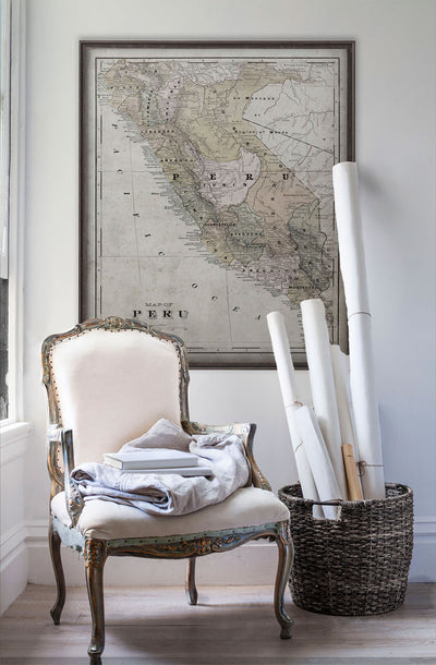 Vintage historic map of Peru in room with white walls with vintage furniture and vintage decor.