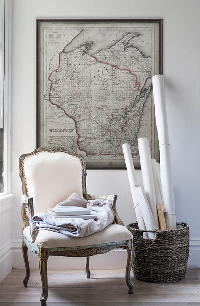 Vintage historic map of Wisconsin in room with white walls with vintage furniture and vintage decor.