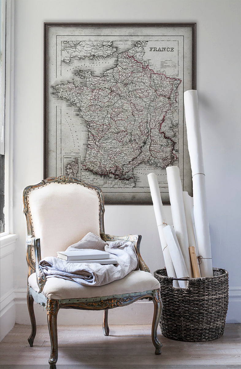 Vintage historic France map in room with white walls with vintage furniture and vintage decor.