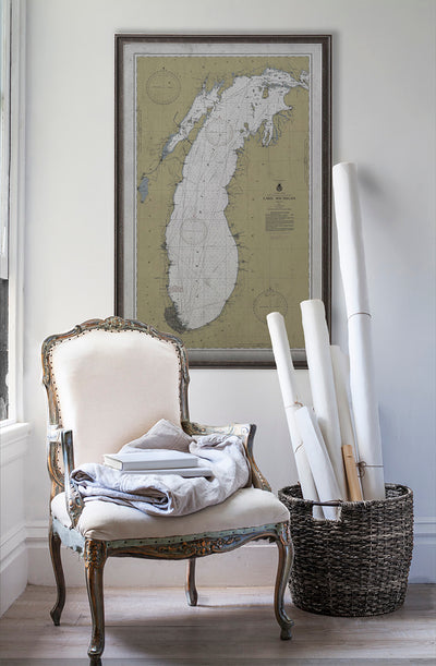 Vintage historic nautical chart of Lake Michigan in room with white walls with vintage furniture and vintage decor.