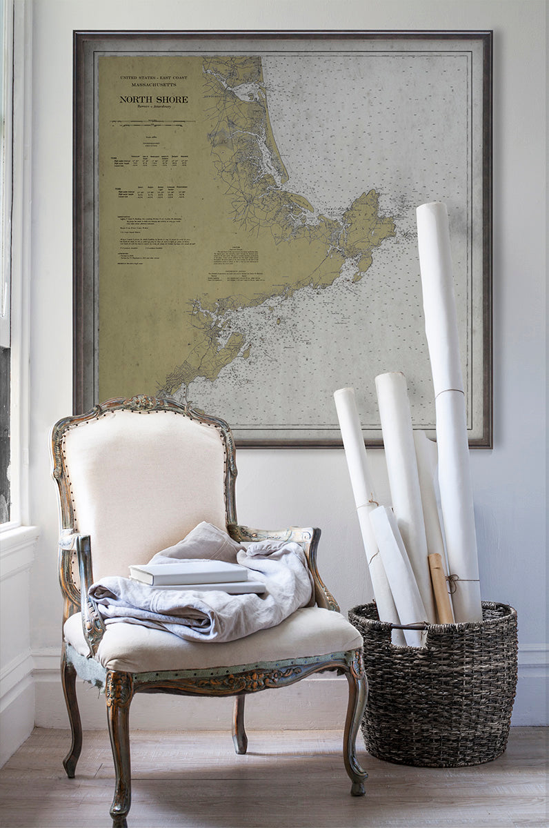 Vintage historic nautical chart of North Shore Massachusetts in room with white walls with vintage furniture and vintage decor.