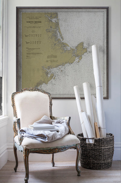 Vintage historic nautical chart of North Shore Massachusetts in room with white walls with vintage furniture and vintage decor.