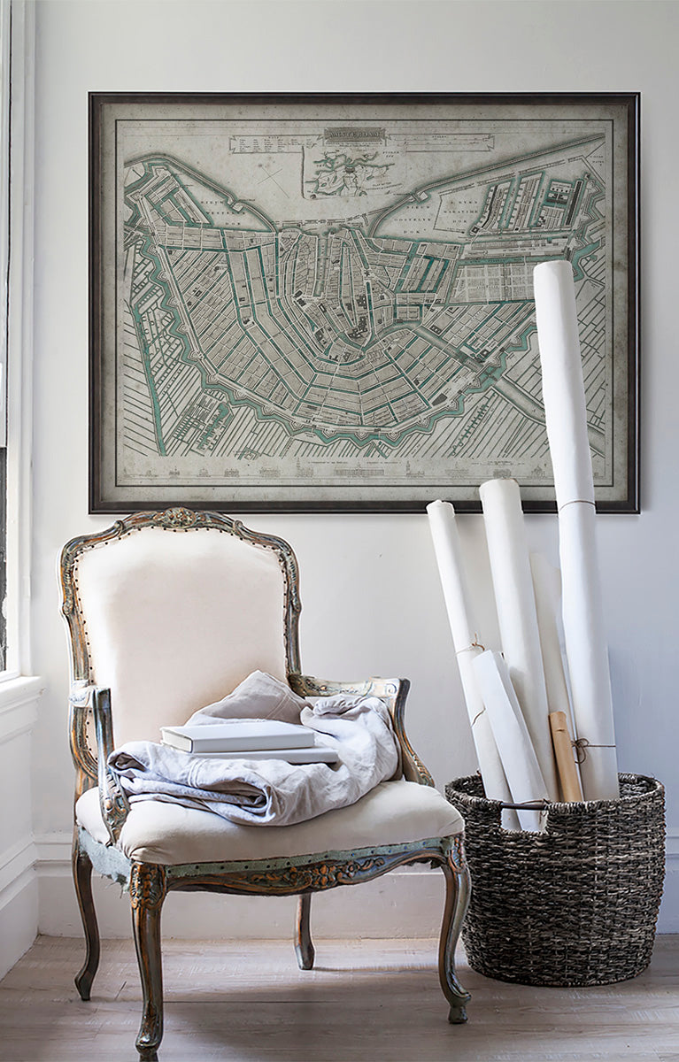 Vintage historic map of Amsterdam on white wall with vintage furniture and vintage decor.
