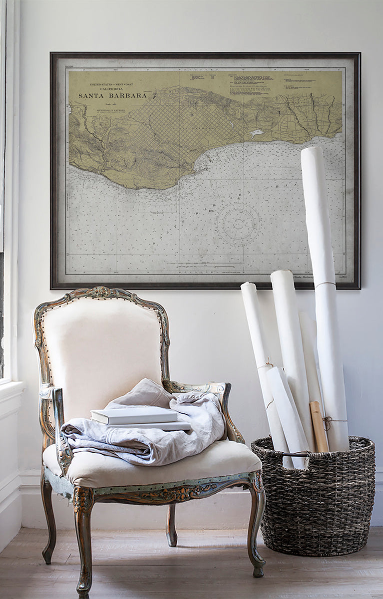 Vintage historic nautical chart of Santa Barbara in room with white walls with vintage furniture and vintage decor.