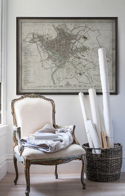 Vintage historic map of Rome, Italy in room with white walls with vintage furniture and vintage decor.
