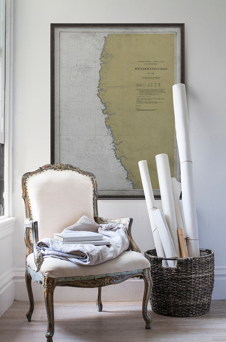 Vintage historic nautical chart of Mendocino in room with white walls with vintage furniture and vintage decor.