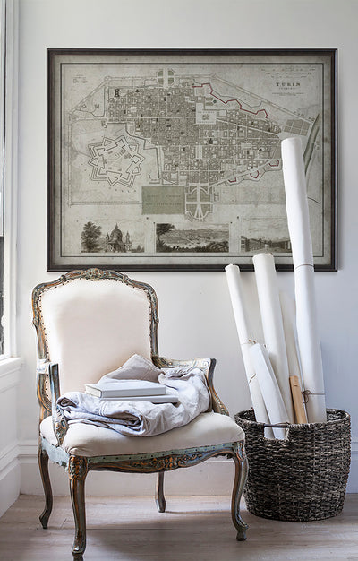 Vintage historic map of Turin, Italy in room with white walls with vintage furniture and vintage decor.