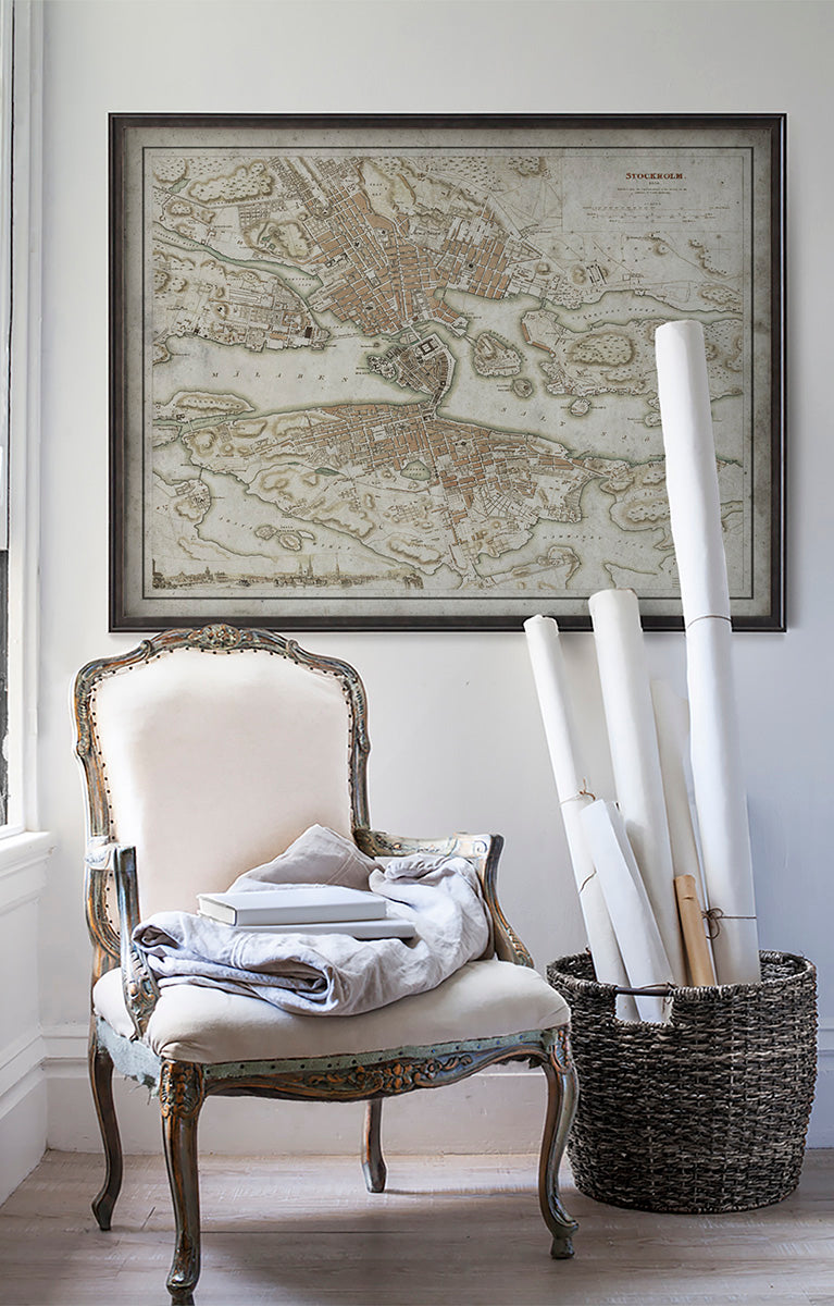 Vintage historic map of Stockholm, Sweden in room with white walls with vintage furniture and vintage decor.