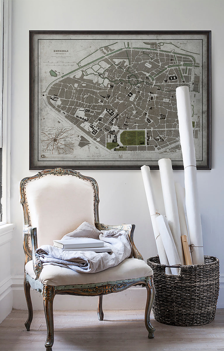 Vintage historic map of Brussels, Belgium in room with white walls with vintage furniture and vintage decor.