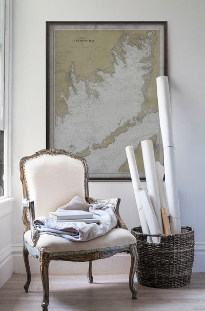 Vintage historic nautical chart of Buzzards Bay in room with white walls with vintage furniture and vintage decor.