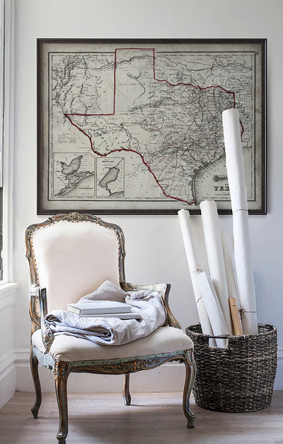 Vintage historic map of Texas in room with white walls with vintage furniture and vintage decor.