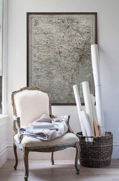 Vintage historic map of Tokyo in room with white walls with vintage furniture and vintage decor.