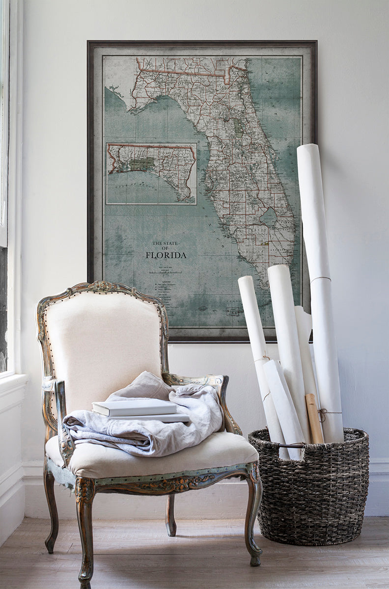 Vintage historic Florida weathered map in room with white walls with vintage furniture and vintage decor.