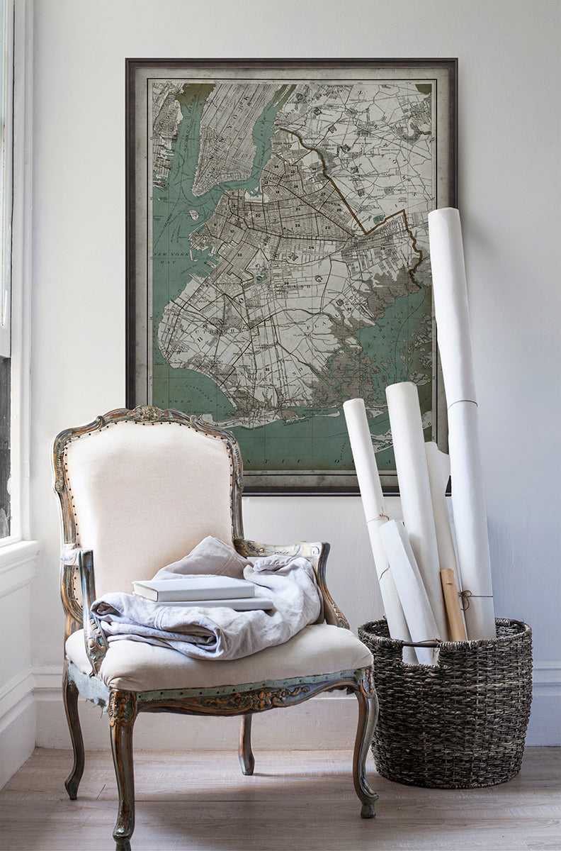 Vintage historic map of Brooklyn in room with white walls with vintage furniture and vintage decor.