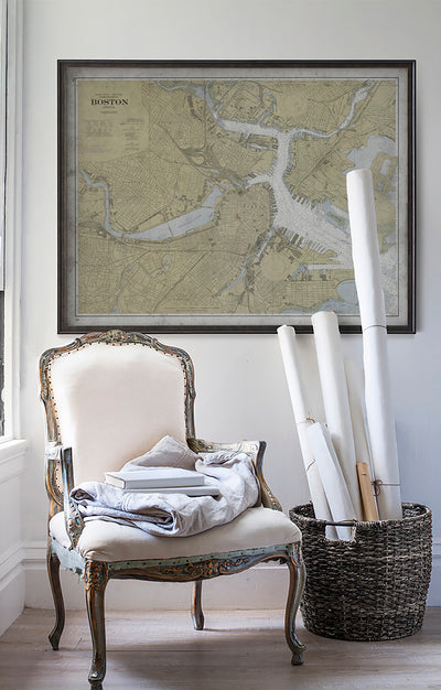 Vintage historic nautical chart of Boston Inner Harbor in room with white walls with vintage furniture and vintage decor.