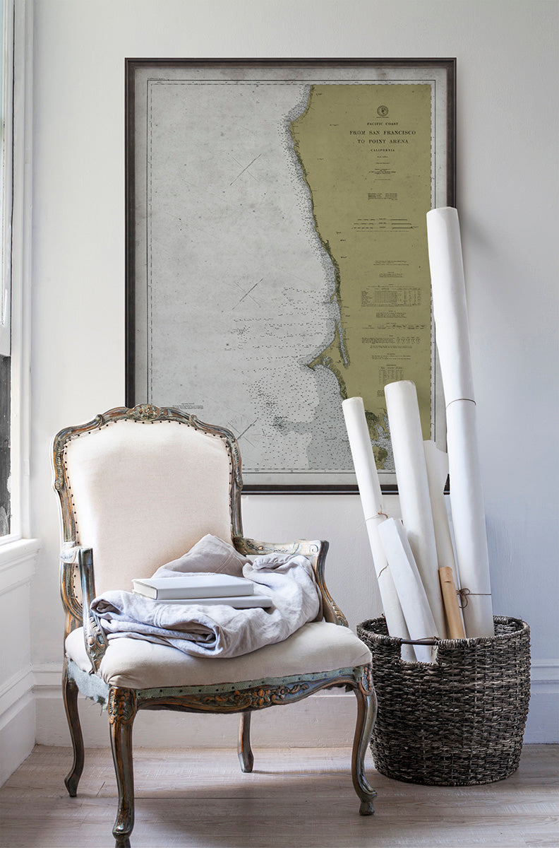 Vintage historic nautical chart of Santa Monica Bay, California in room with white walls with vintage furniture and vintage decor.