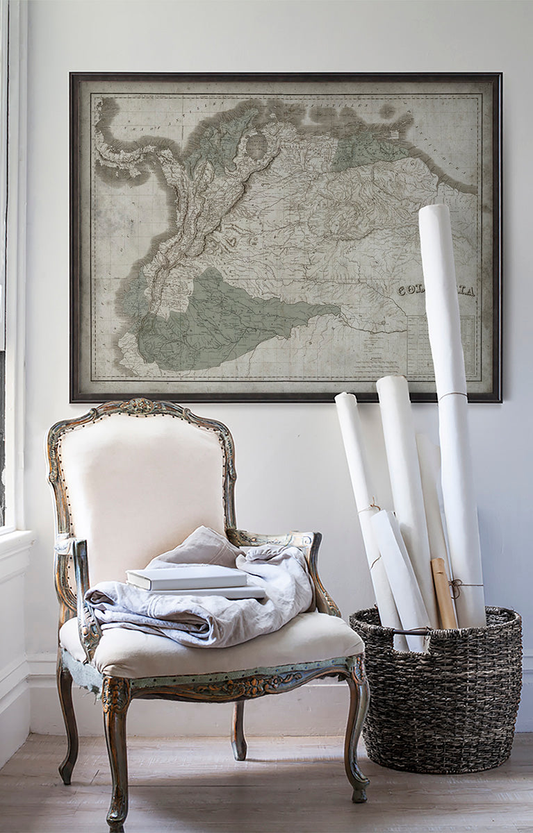 Vintage historic map of Colombia in room with white walls with vintage furniture and vintage decor.