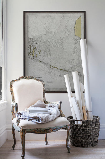 Vintage historic nautical chart of Florida Reefs in room with white walls with vintage furniture and vintage decor.