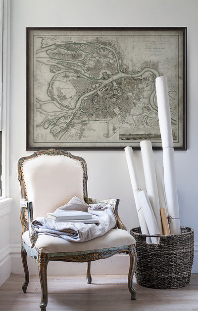 Vintage historic map of St. Petersburg in room with white walls with vintage furniture and vintage decor.