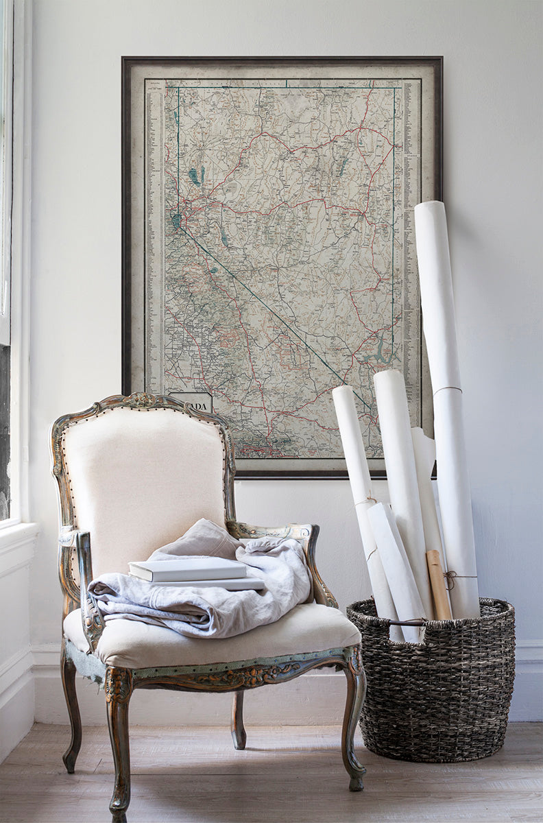 Vintage historic map of Nevada in room with white walls with vintage furniture and vintage decor.