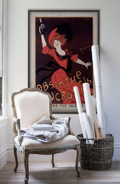 absinthe vintage wall art poster on white wall with vintage furniture and vintage decor.