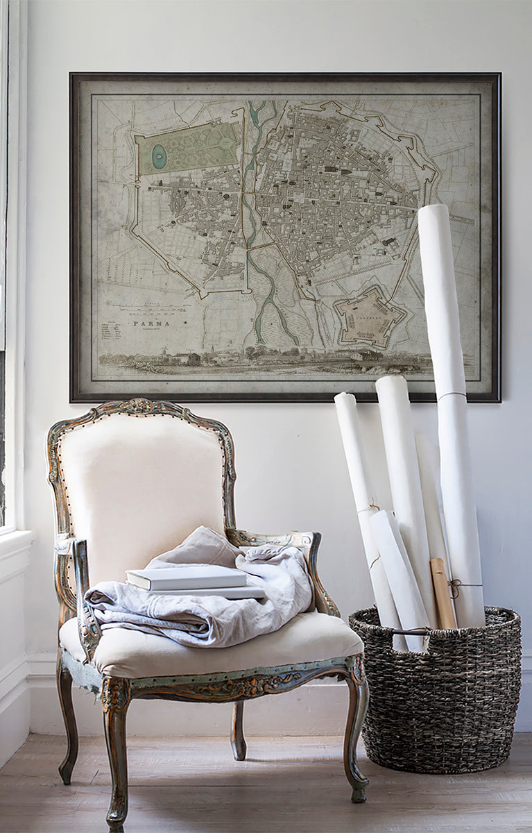 Vintage historic map of Parma, Italy in room with white walls with vintage furniture and vintage decor.