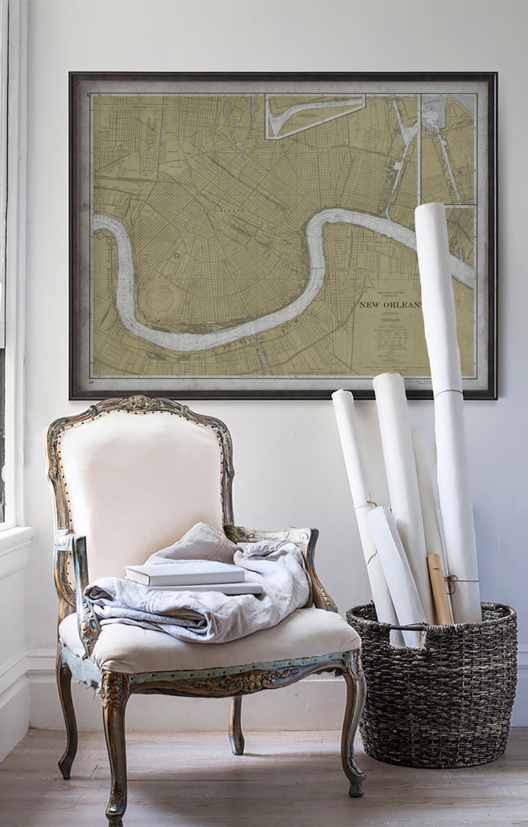 Vintage historic nautical chart of New Orleans in room with white walls with vintage furniture and vintage decor.