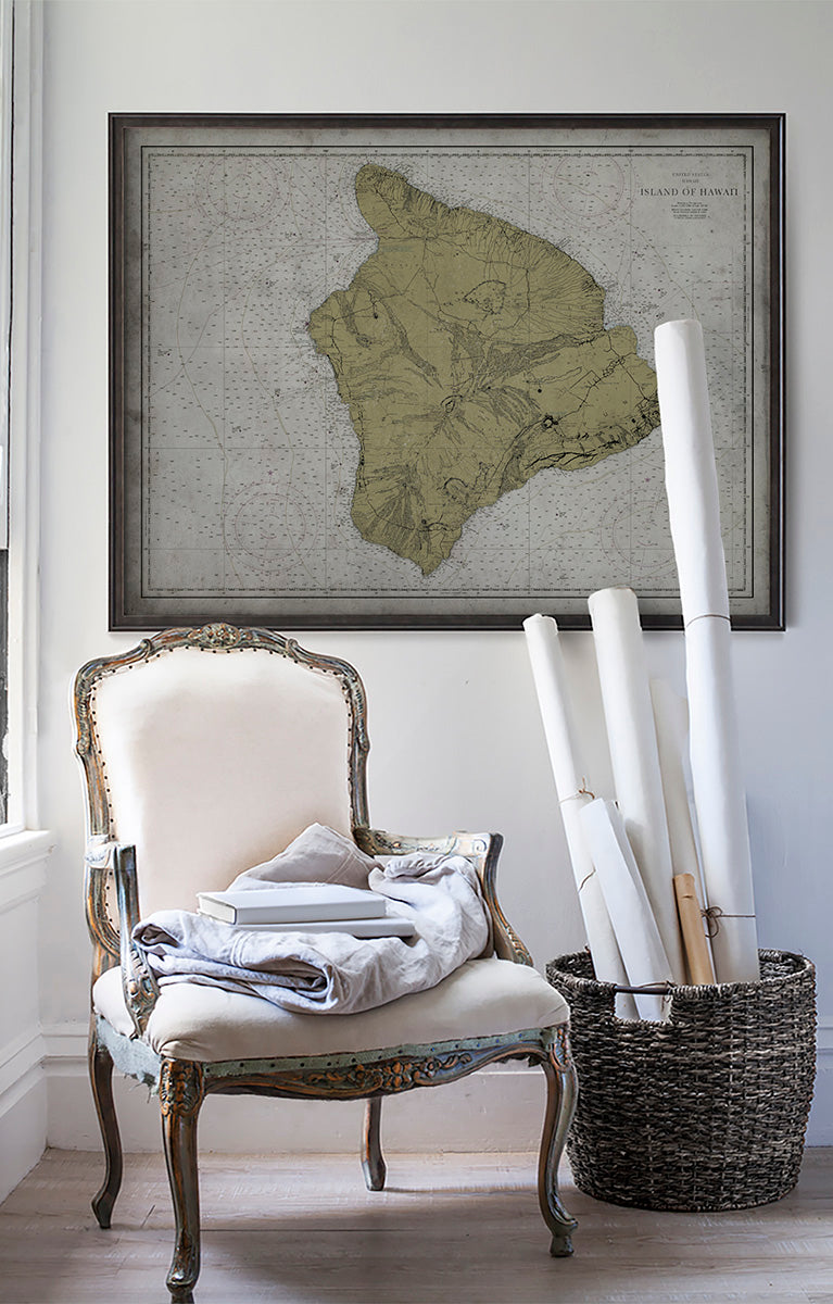 Vintage historic nautical chart of Hawaii in room with white walls with vintage furniture and vintage decor.