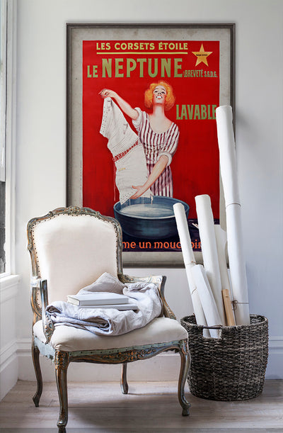 Les Corsets Étoile Le Neptune vintage poster wall art on white wall with vintage furniture and vintage decor.