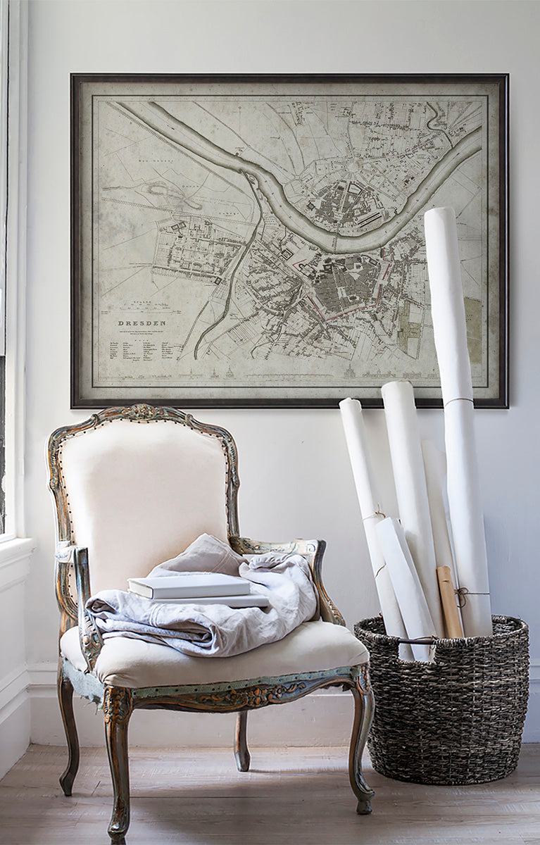 Vintage historic Dresden map in room with white walls with vintage furniture and vintage decor.