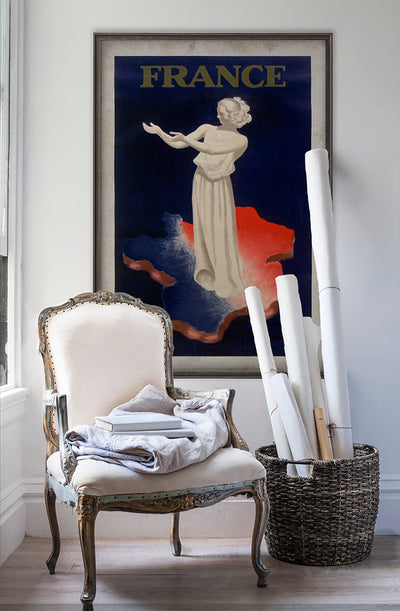 "France" French Olympics vintage poster wall art on white wall with vintage furniture and vintage decor.