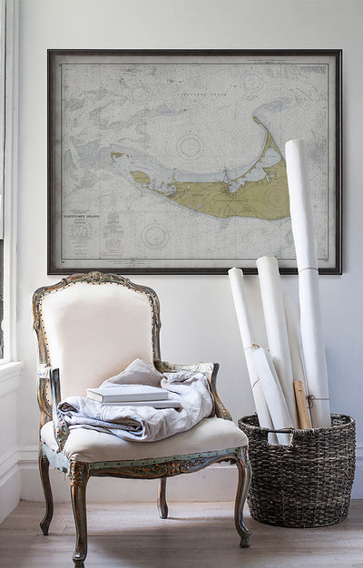 Vintage historic nautical chart of Nantucket in room with white walls with vintage furniture and vintage decor.