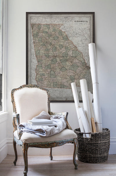 Vintage historic Georgia map in room with white walls with vintage furniture and vintage decor.