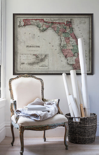 Vintage historic Florida map in room with white walls with vintage furniture and vintage decor.