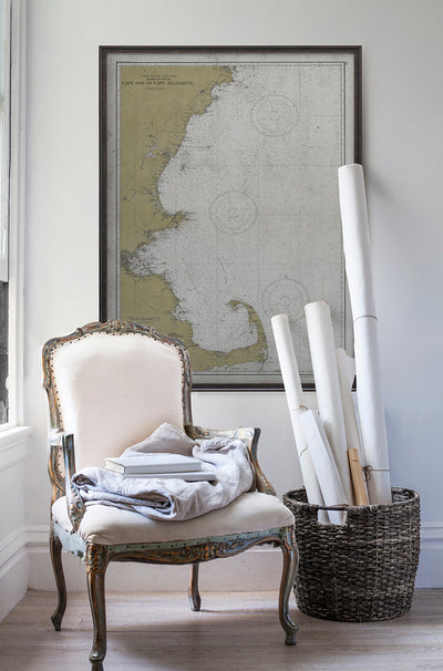 Vintage historic nautical chart of Cape Elizabeth to Cape Cod in room with white walls with vintage furniture and vintage decor.
