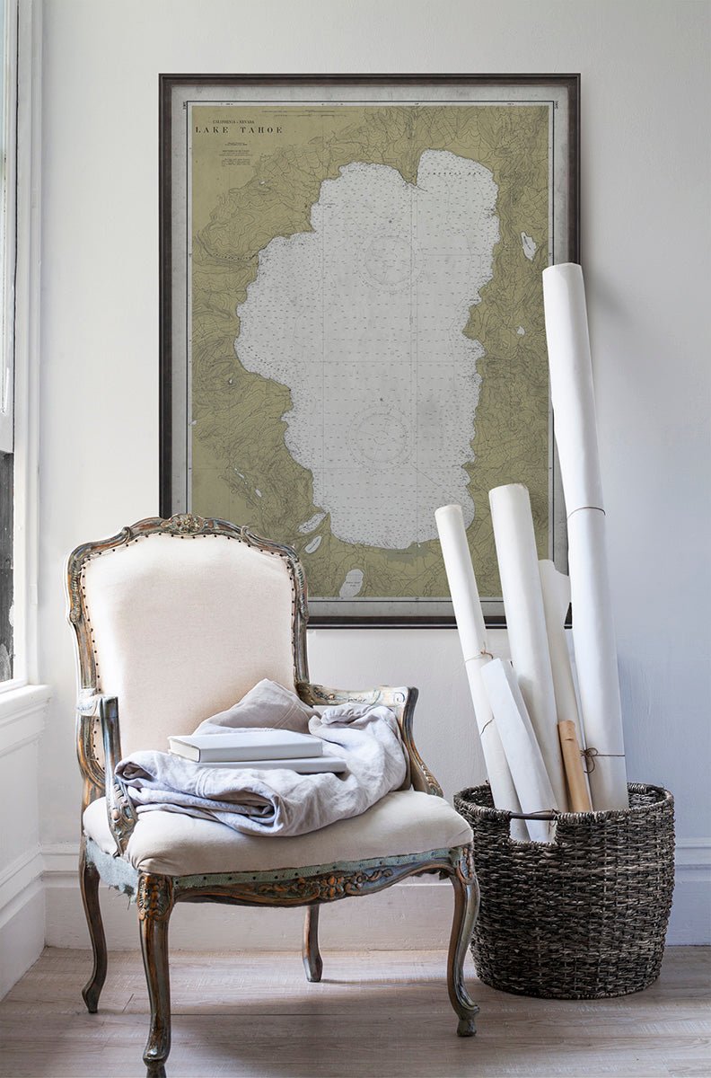 Vintage historic nautical chart of Lake Tahoe in room with white walls with vintage furniture and vintage decor.