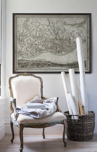 Vintage historic Lisbon, Portugal map in room with white walls with vintage furniture and vintage decor.