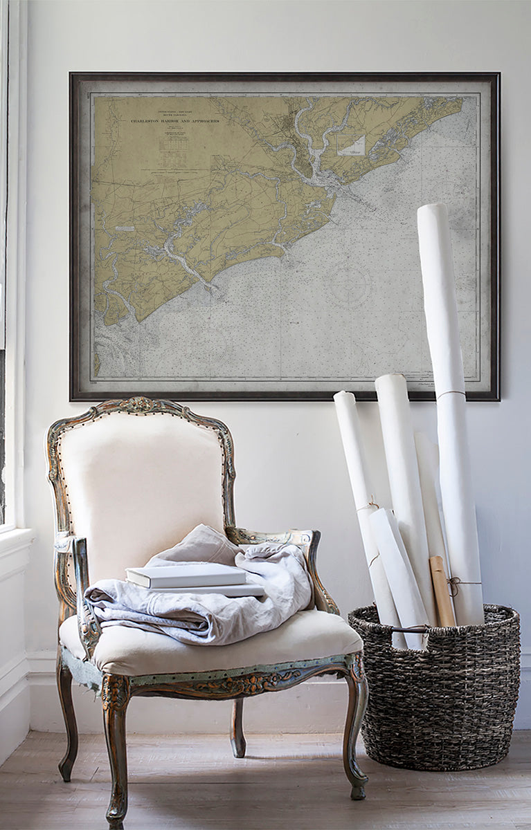 Vintage historic nautical chart of Charleston Approaches in room with white walls with vintage furniture and vintage decor.