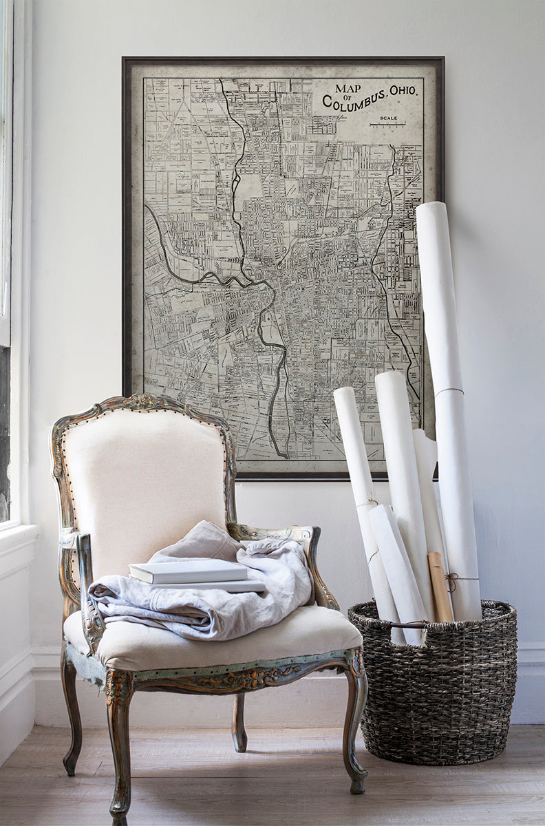 Vintage historic map of Columbus, Ohio in room with white walls with vintage furniture and vintage decor.
