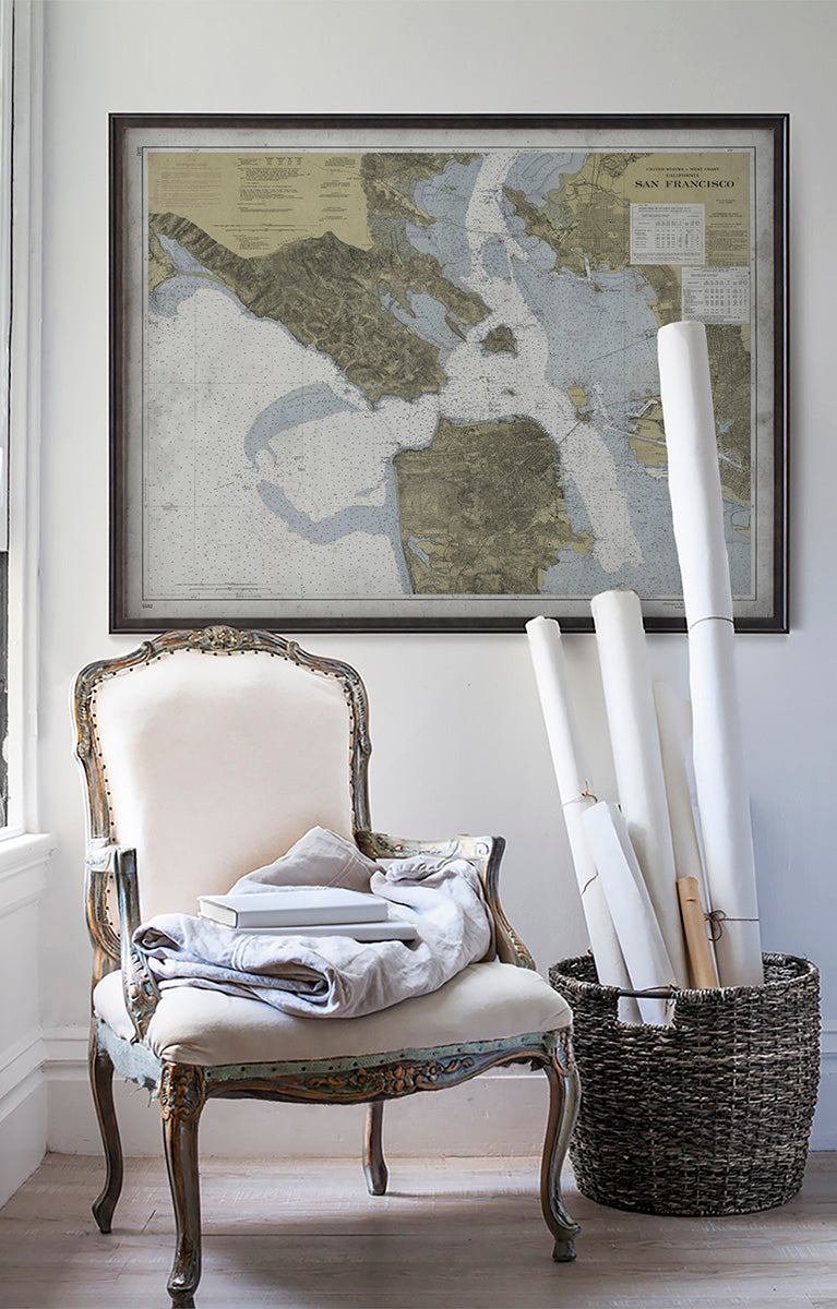 Vintage historic nautical chart of San Francisco Bay Area in room with white walls with vintage furniture and vintage decor.