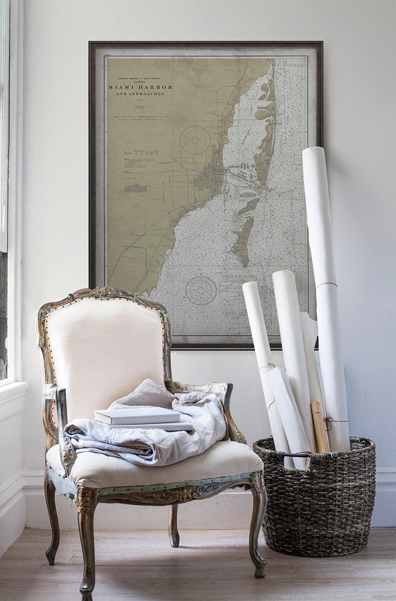 Vintage historic nautical chart of Miami in room with white walls with vintage furniture and vintage decor.