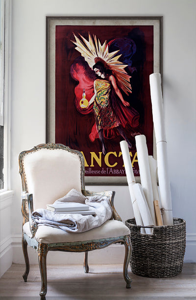 Sancta vintage poster wall art on white wall with vintage furniture and vintage decor.