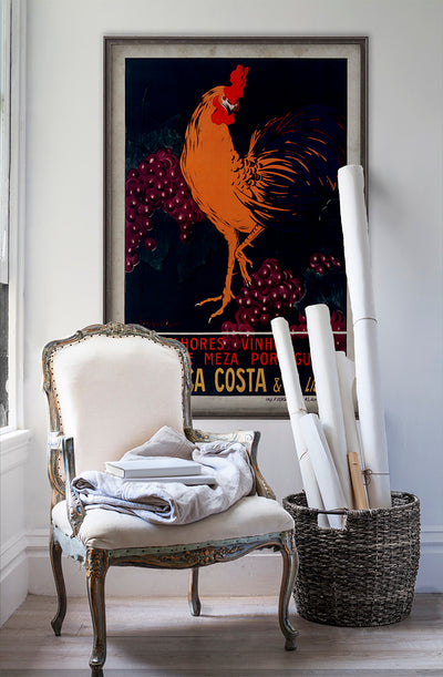 Fonseca Costa vintage poster wall art on white wall with vintage furniture and vintage decor.