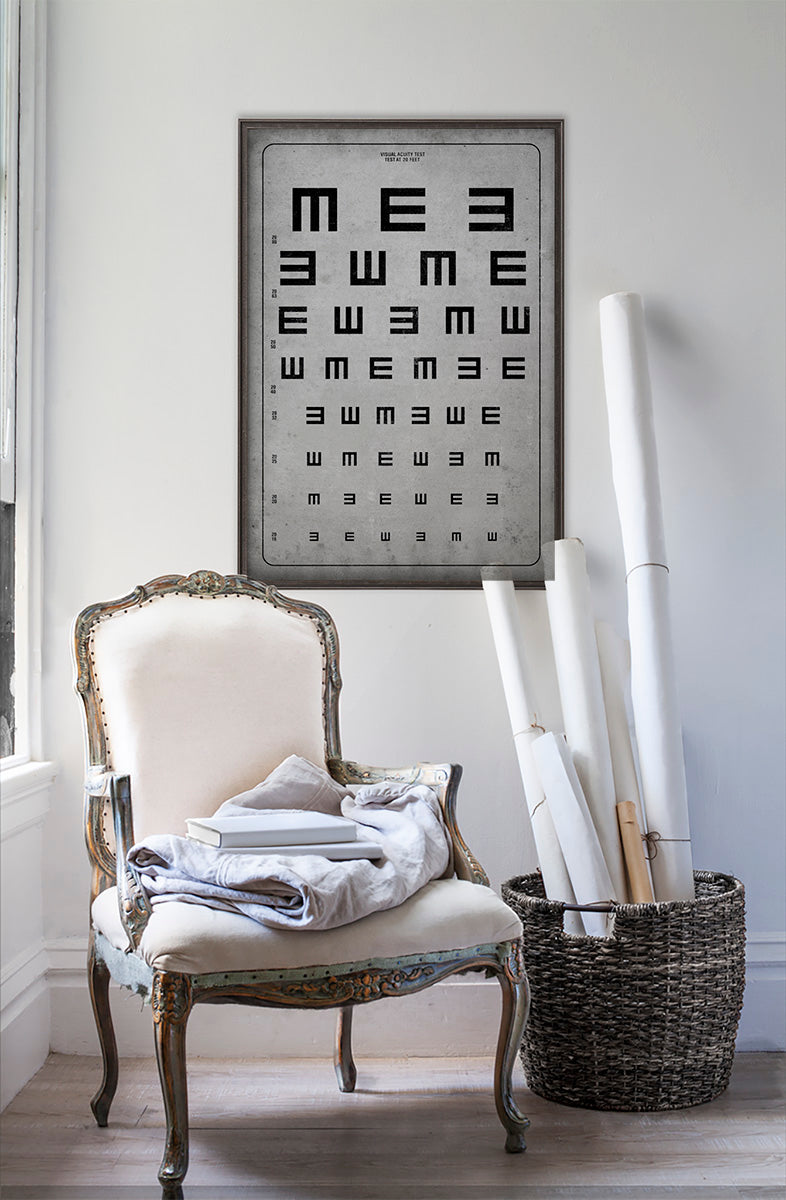 vintage Tumbling "E" vision chart  in room with white walls with vintage furniture and vintage decor.